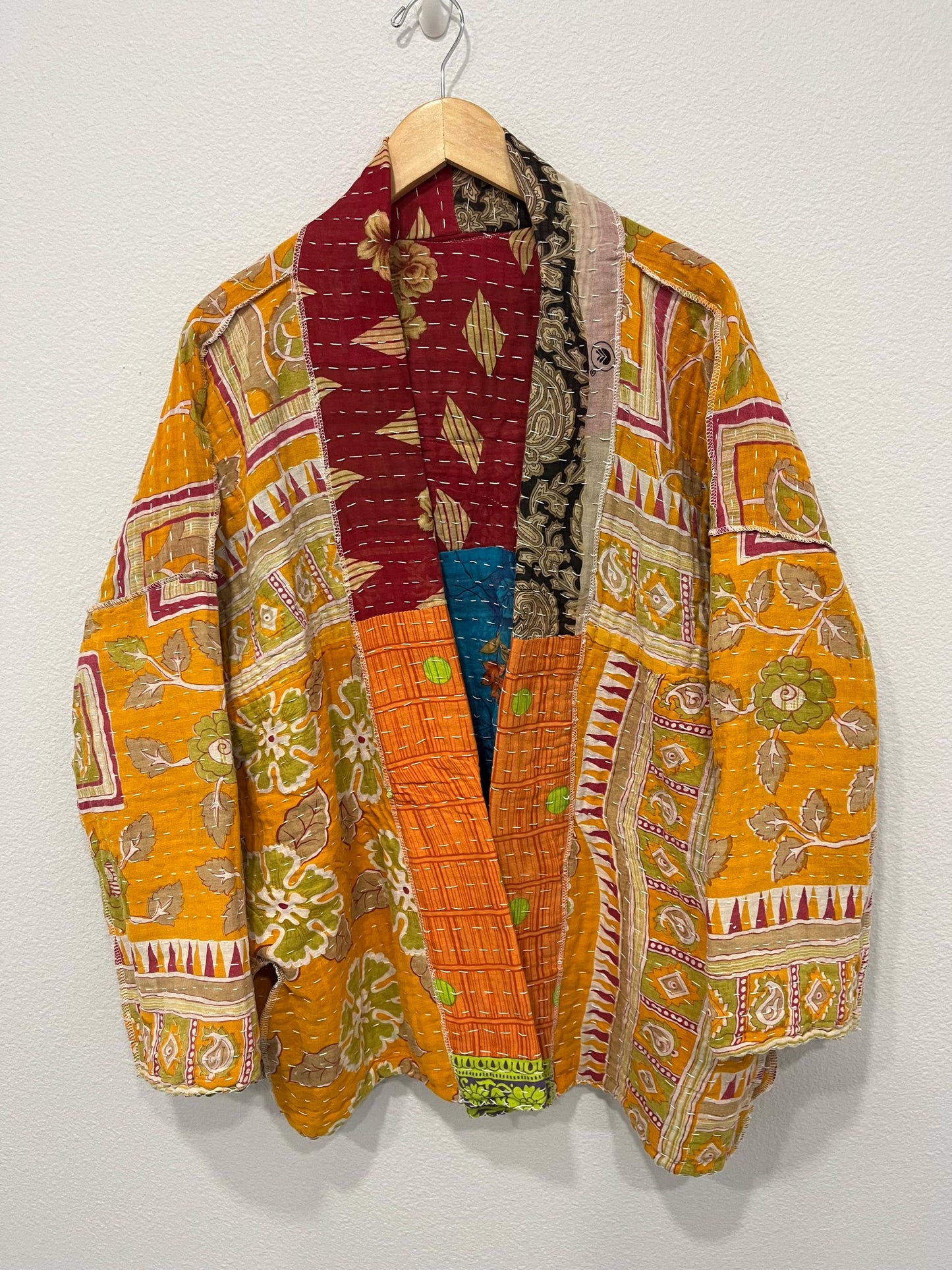 Luxury, unique, reversible, quilted jacket made for easy travel. This is multicolor with a patchwork effect made of Kantha Cloth.