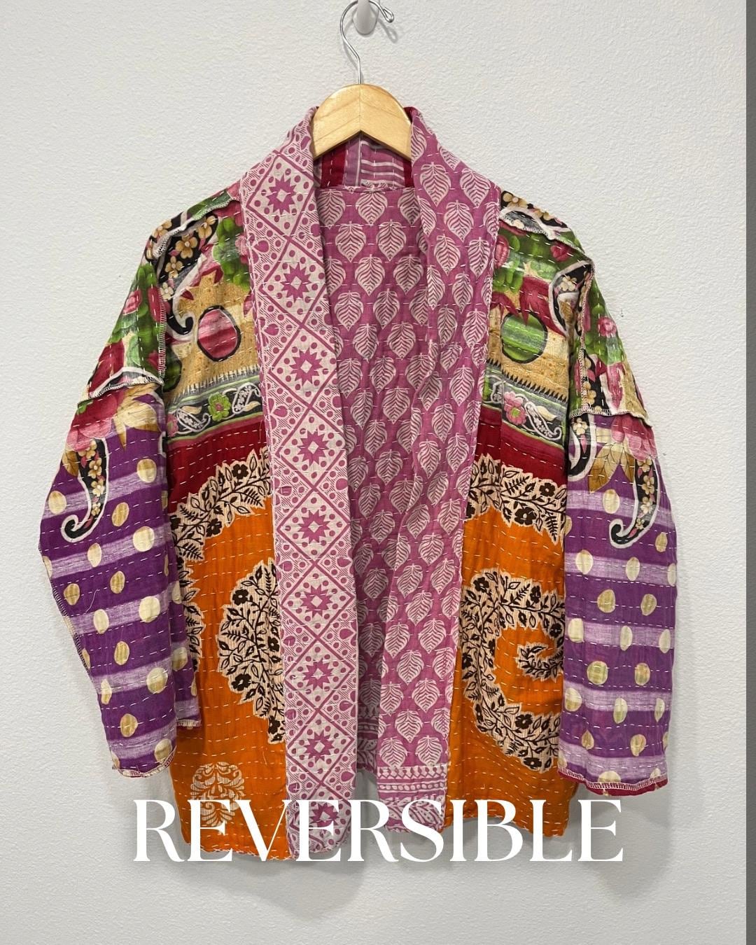 Unique, reversible quilted jacket. This Jacket is a lavender print fabric with red trim around the wrist. It is also soft and comfortable with pockets