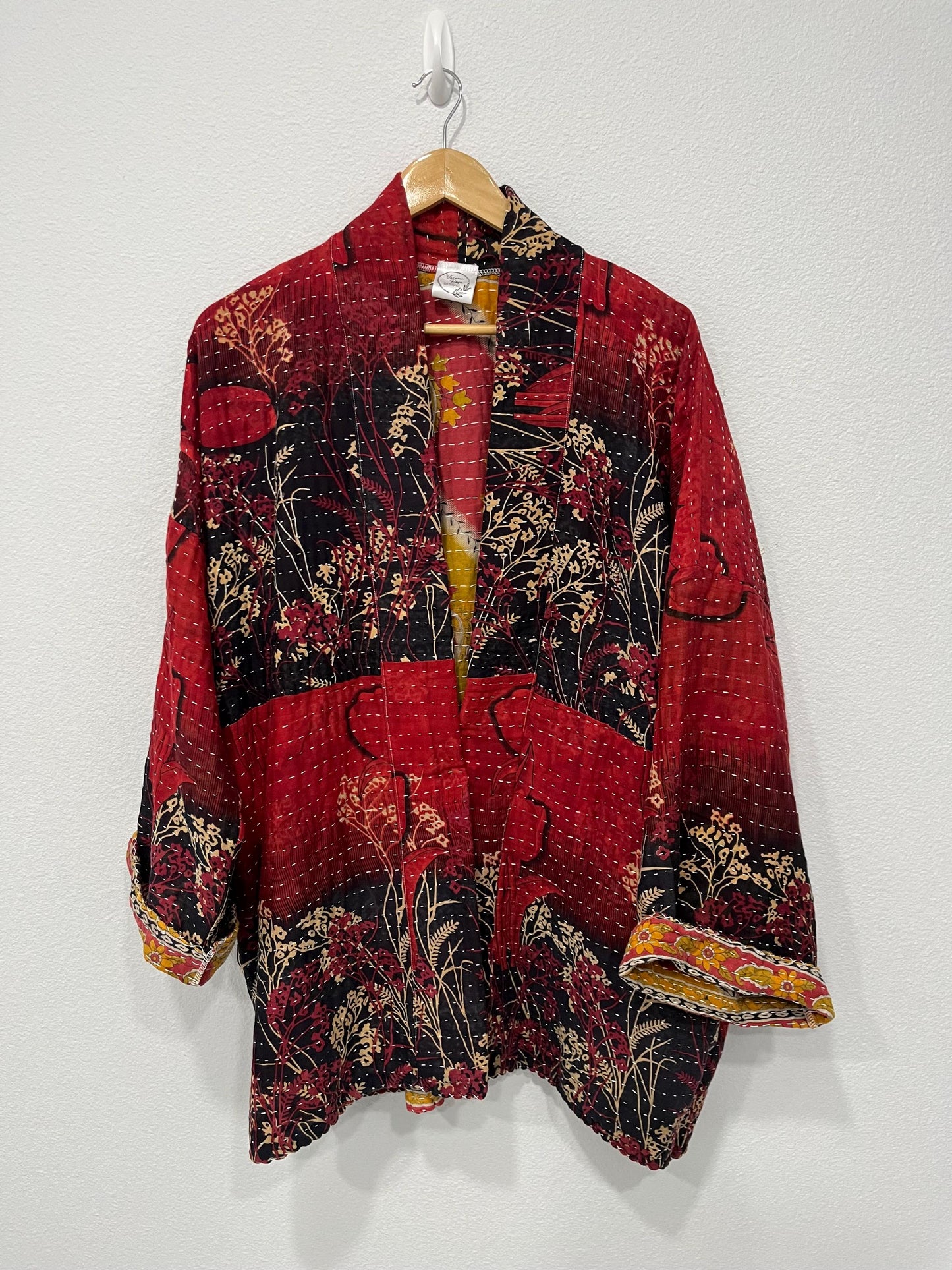 Unique, reversible quilted statement jacket made for easy travel with Red and Black floral Kantha Cloth.