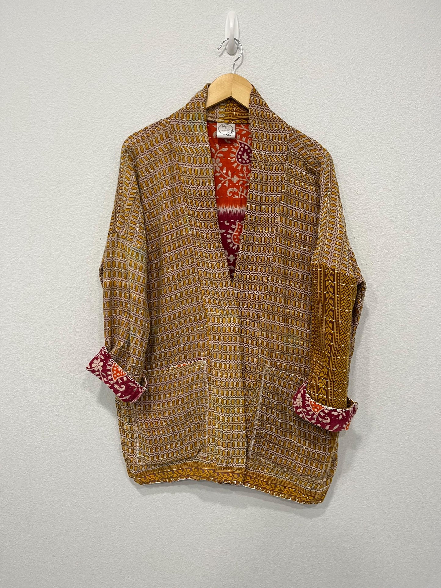 Unique, reversible Quilted statement Jacket for women who travel in style.  It is a Medium Gold and Dark Gold geometric pattern and large pockets. Wear as a Casual weekend outfit or office wear over a dress.
