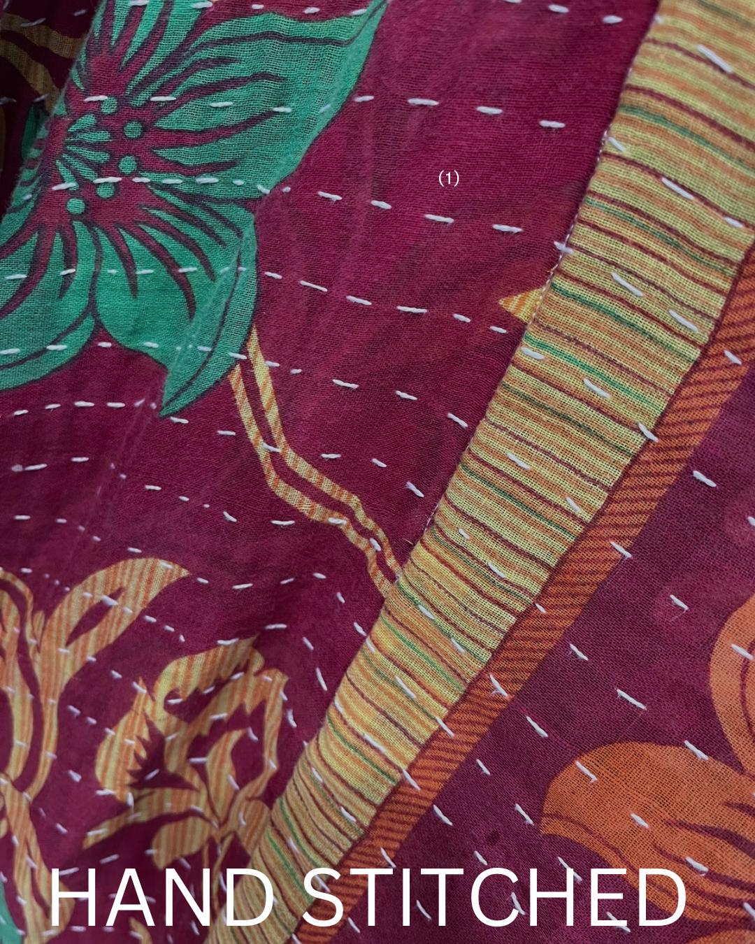 This One-of-a-kind Quilted Red, Green, and Gold jacket with Beige Sleeves is made from Kantha Cloth. It is great for traveling as it is reversible for 2 looks in one, and light weight for easy packing.