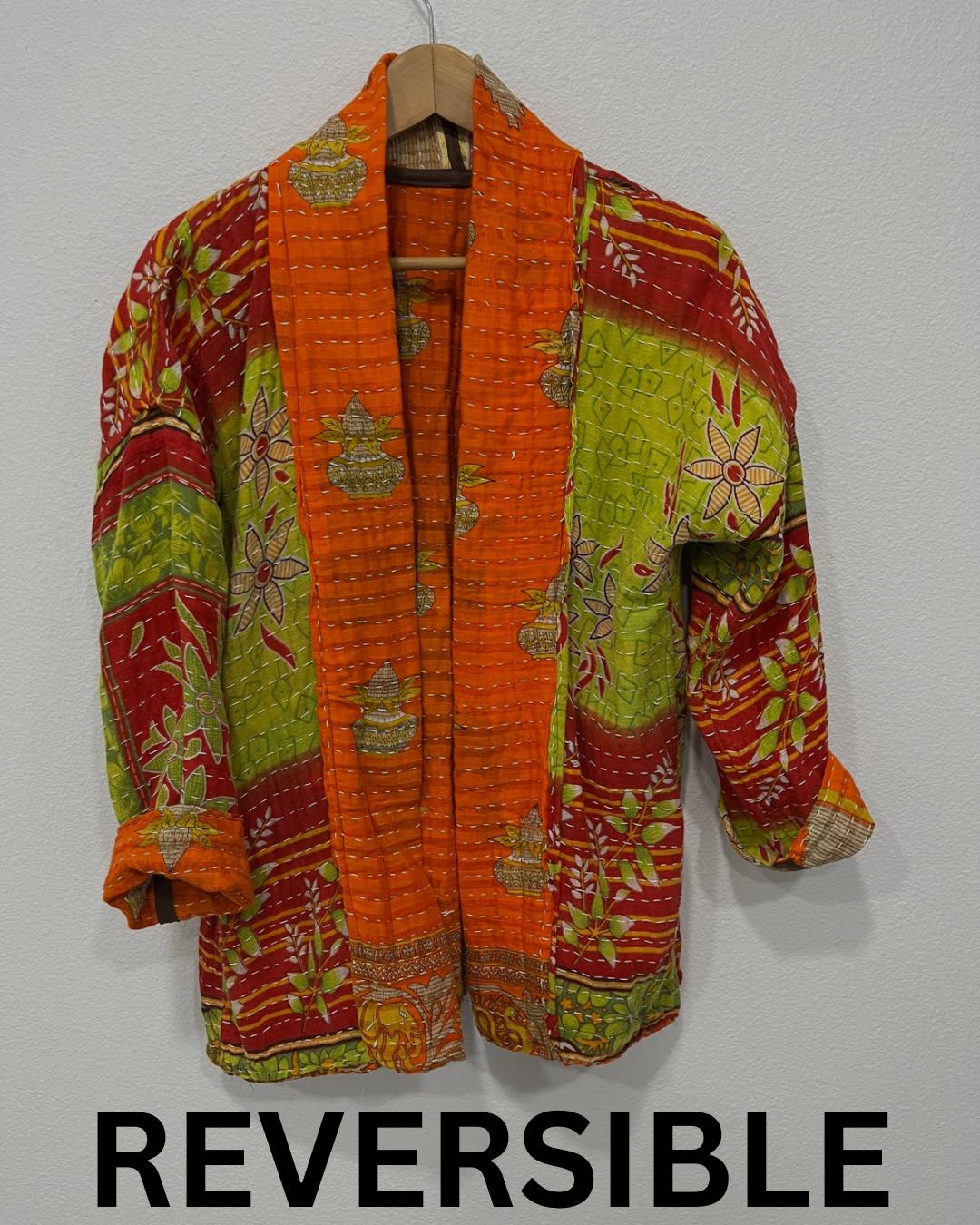 One-of-A-Kind quilted orange jacket with brown piping and pockets. Handmade with Kantha Cloth (procured through Fair Trade) and reversible