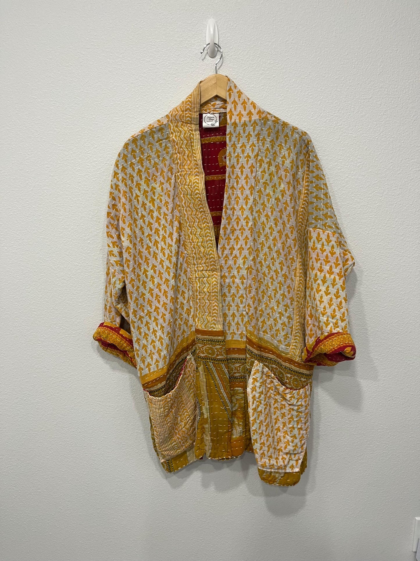 This Yellow, gold and white geometric designed luxury, unique, reversible quilted jacket made for easy traveling in style.