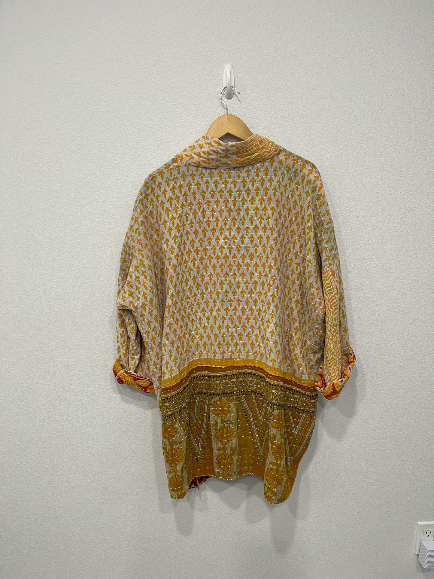 This Yellow, gold and white geometric designed luxury, unique, reversible quilted jacket made for easy traveling in style.