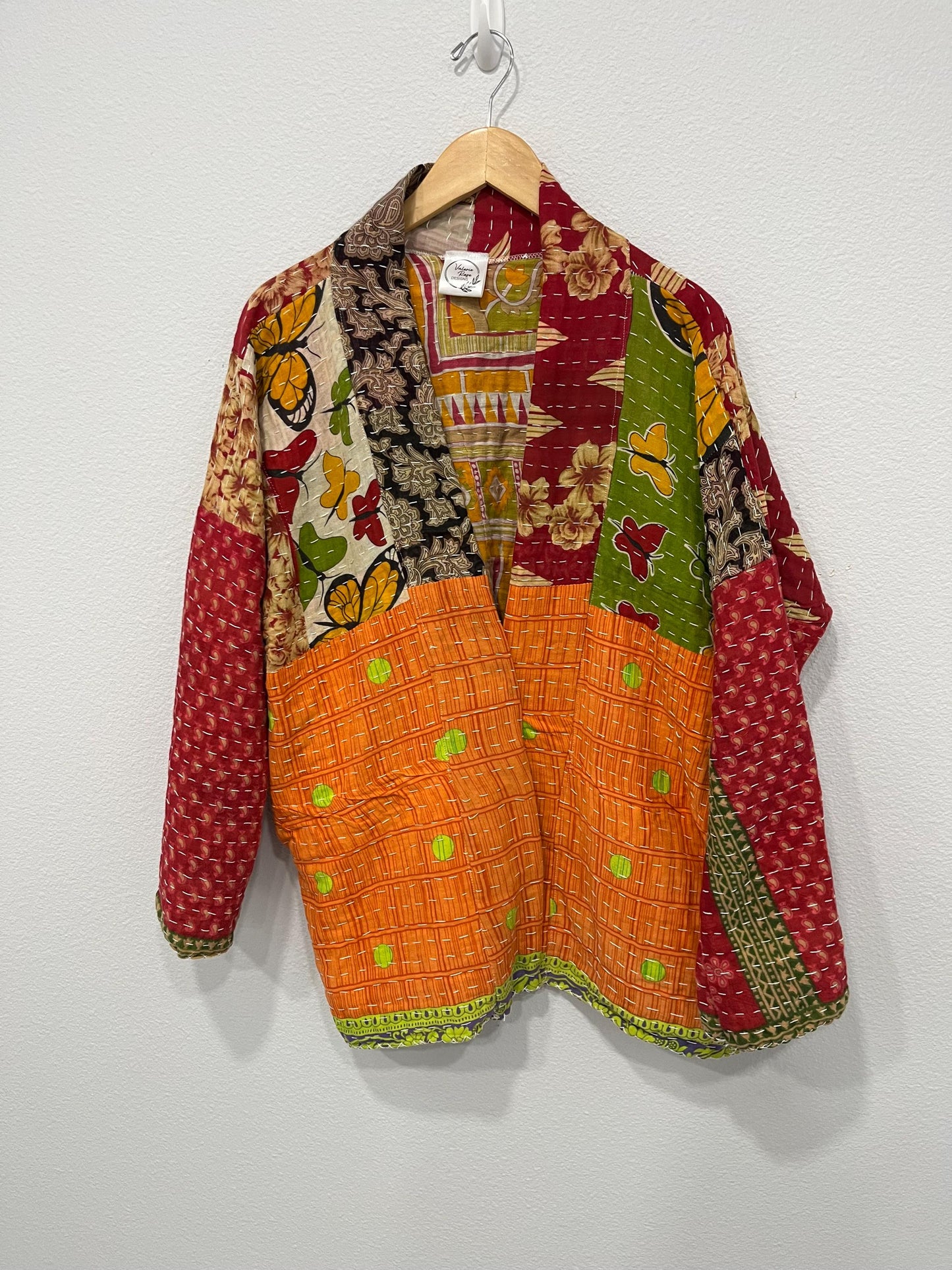 Luxury, unique, reversible, quilted jacket made for easy travel. This is multicolor with a patchwork effect made of Kantha Cloth.