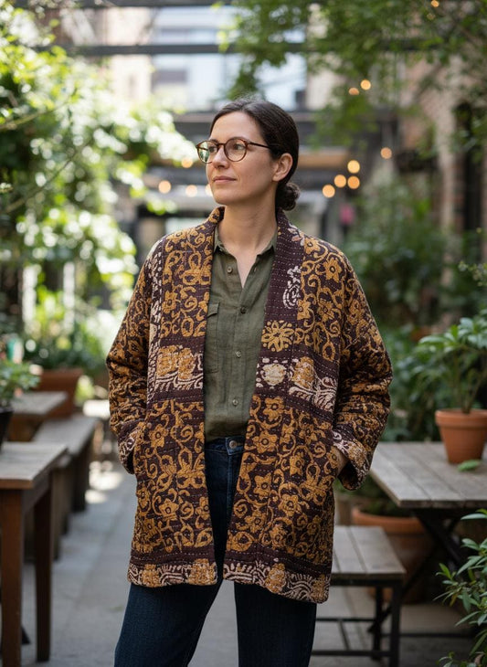 This is a unique, quilted dark burgundy and Dark gold quilted statement jacket with large pockets made for easy traveling in style.