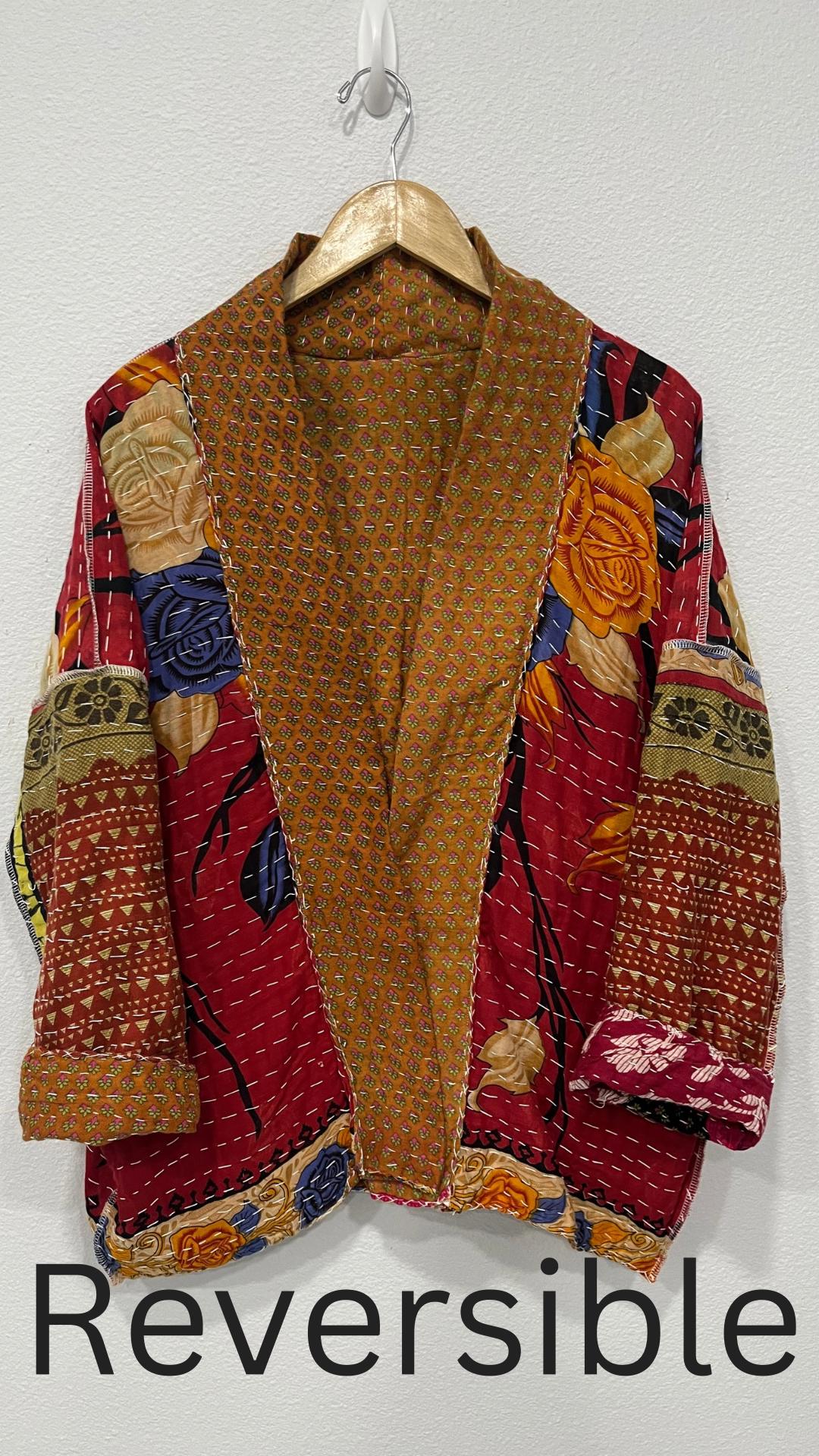 This one-of-a-kind quilted brown-gold small floral print and pink upper arm bands jacket is made of Kantha Cloth. It is wonderful for traveling as it is reversible for 2 looks in one and it is light weight for easy packing.