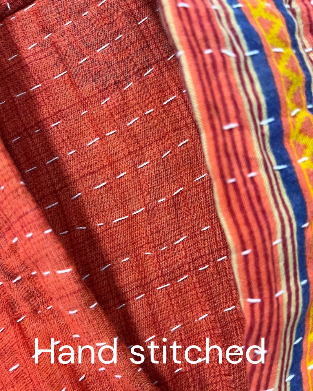 Reversible, unique, reversible quilted statement Jacket made for women who want to travel in style. This Coral Hand Stitched, Boho Artisan Coat is trimmed in beige piping with royal blue pockets and edges the bottom of the jacket.