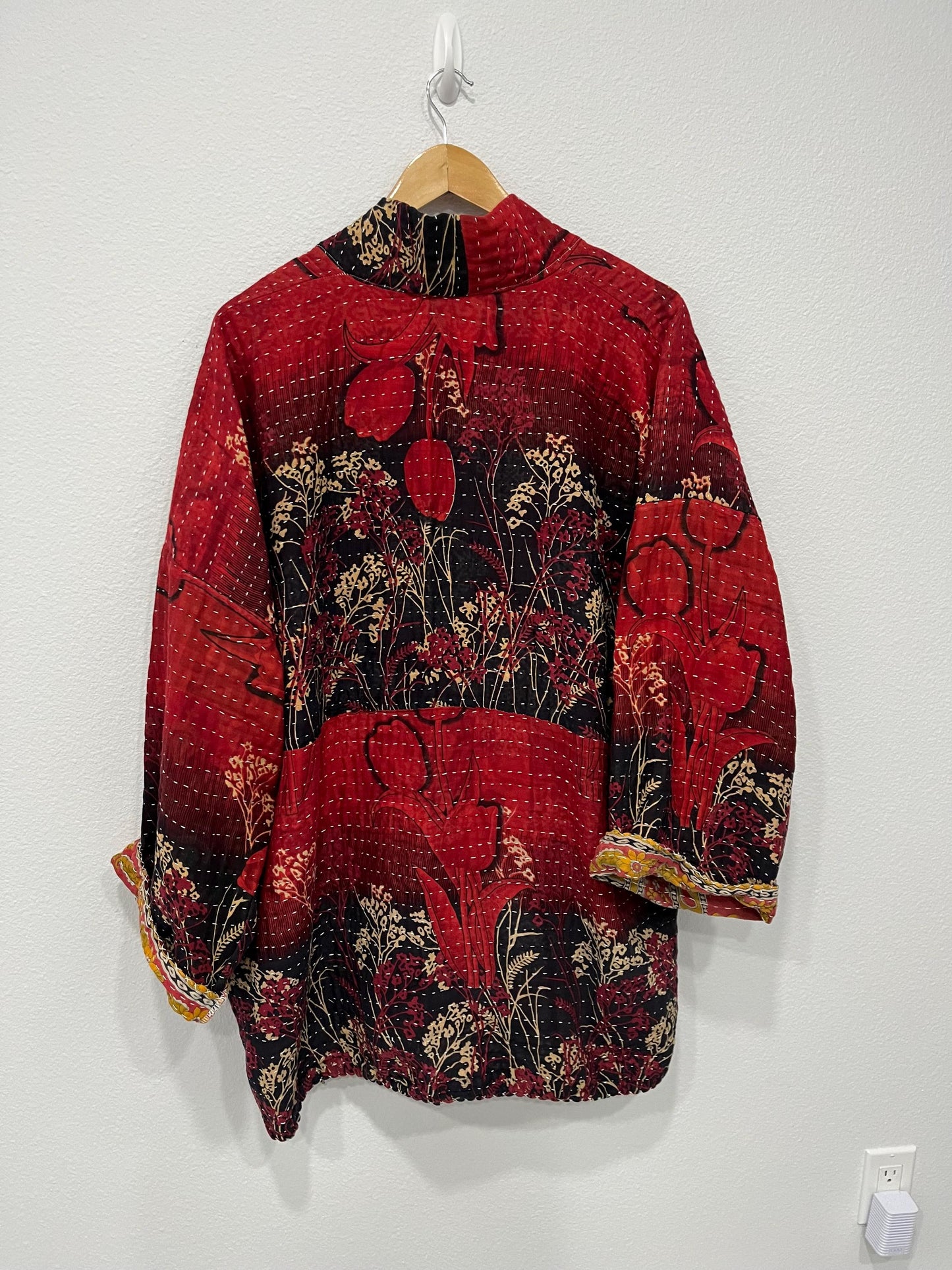 Unique, reversible quilted statement jacket made for easy travel with Red and Black floral Kantha Cloth.