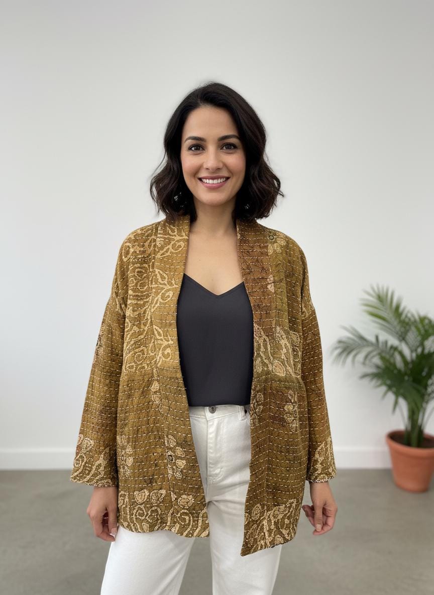 Luxury, unique, reversible quilted statement coat made for the stylish woman wanting quality over quantity. It is a light brown and beige print fabric with hot pink floral fabric inside.