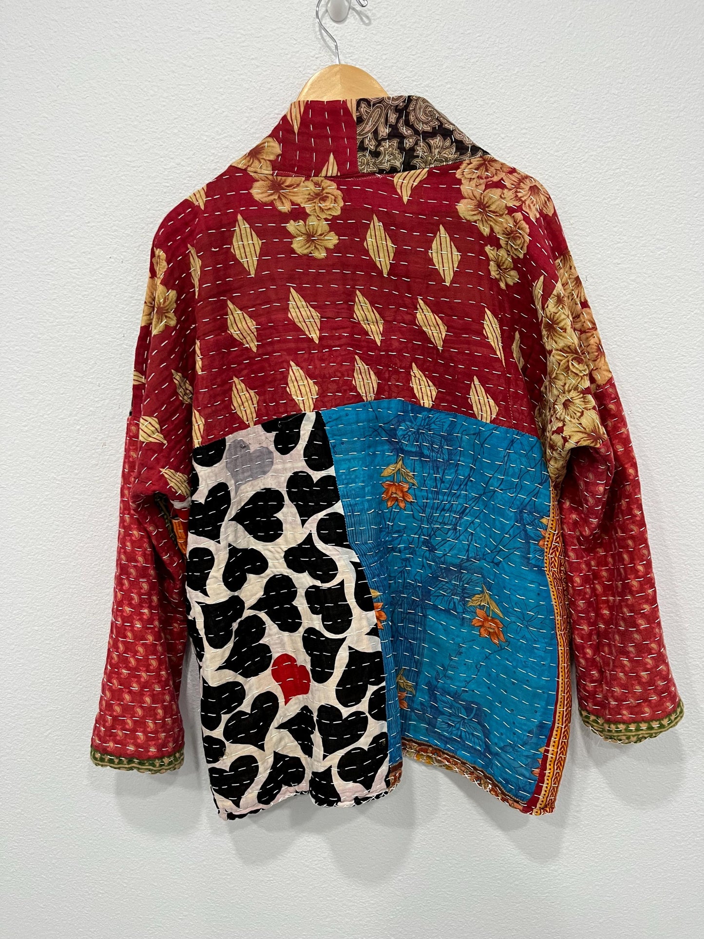 Luxury, unique, reversible, quilted jacket made for easy travel. This is multicolor with a patchwork effect made of Kantha Cloth.