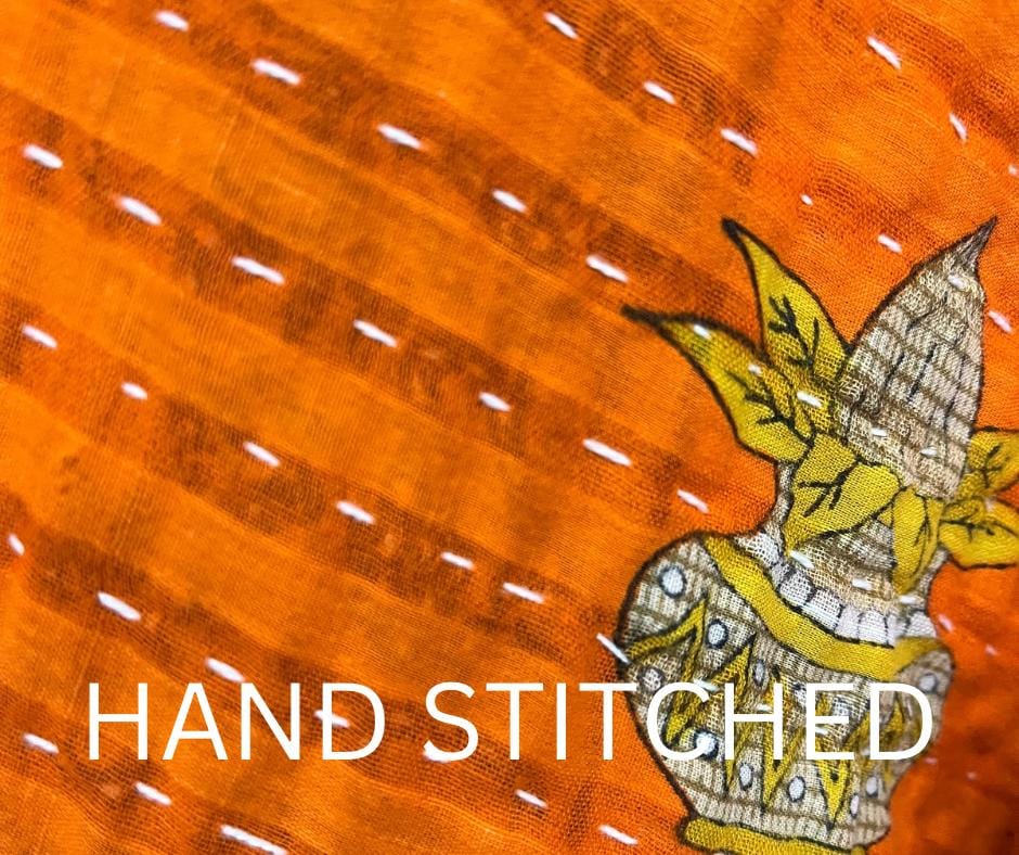 One-of-A-Kind quilted orange jacket with brown piping and pockets. Handmade with Kantha Cloth (procured through Fair Trade) and reversible